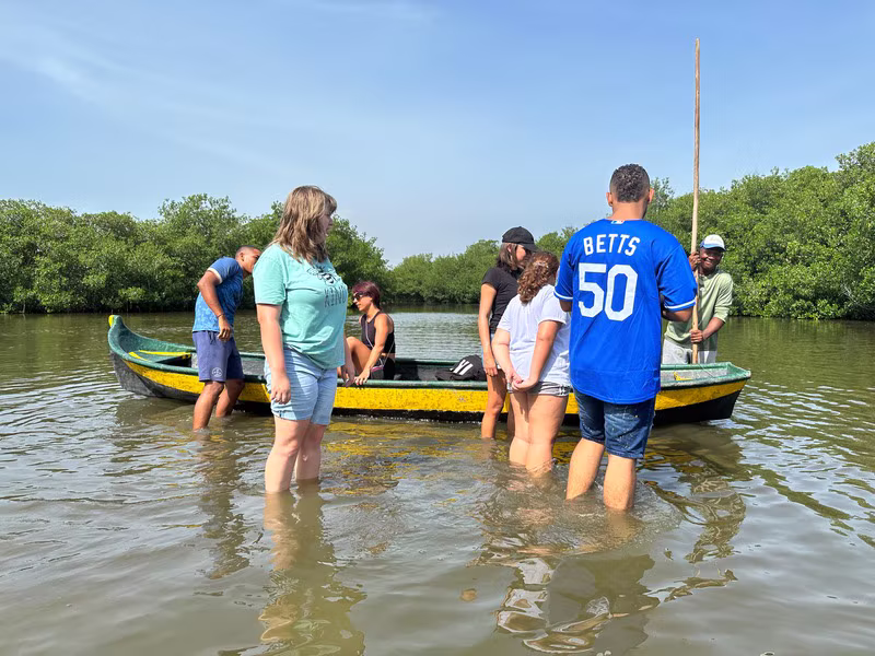 Wading out to the canoe in the shallows of the lagoon
